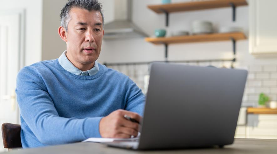Middle-aged man using laptop 